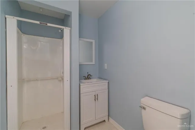 a bathroom with a toilet sink and vanity