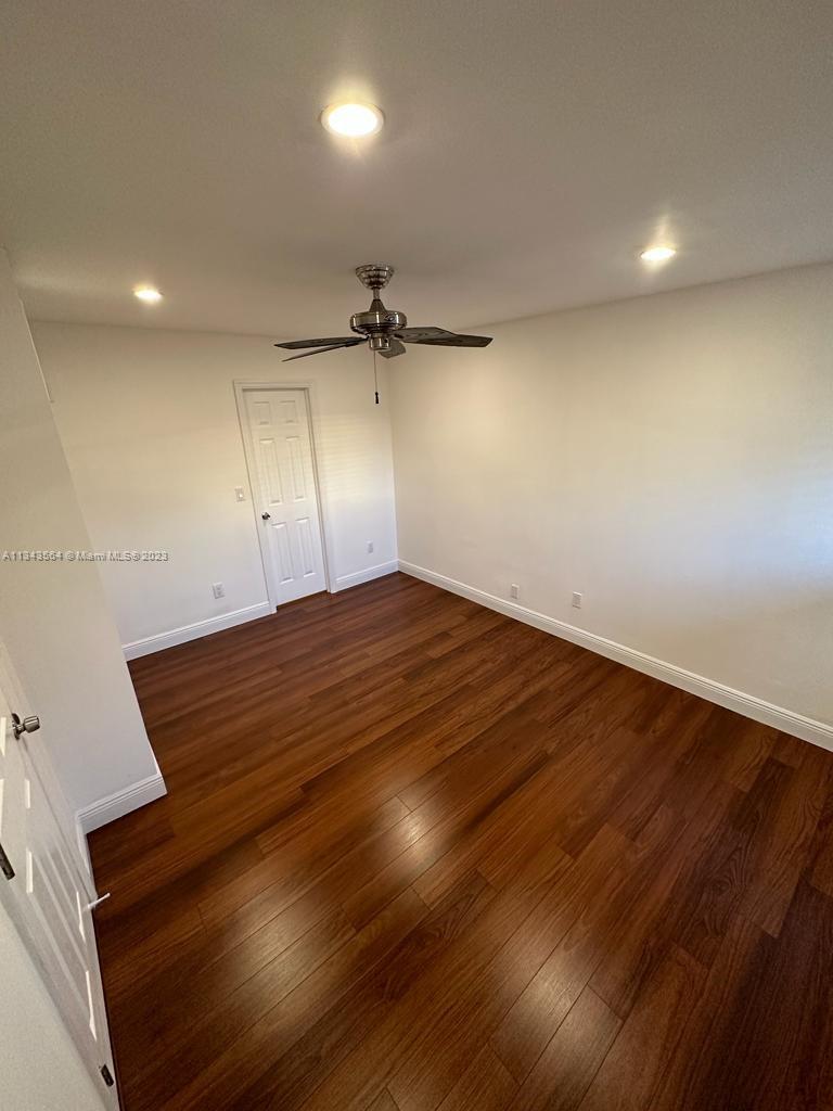 Snapper Creek Townhouses Miami, FL 33173 - Photo 16 of 22 an empty room with wooden floor