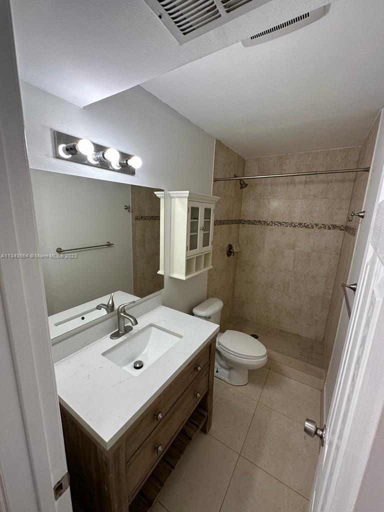 Snapper Creek Townhouses Miami, FL 33173 - Photo 8 of 22 a bathroom with a sink a toilet and shower