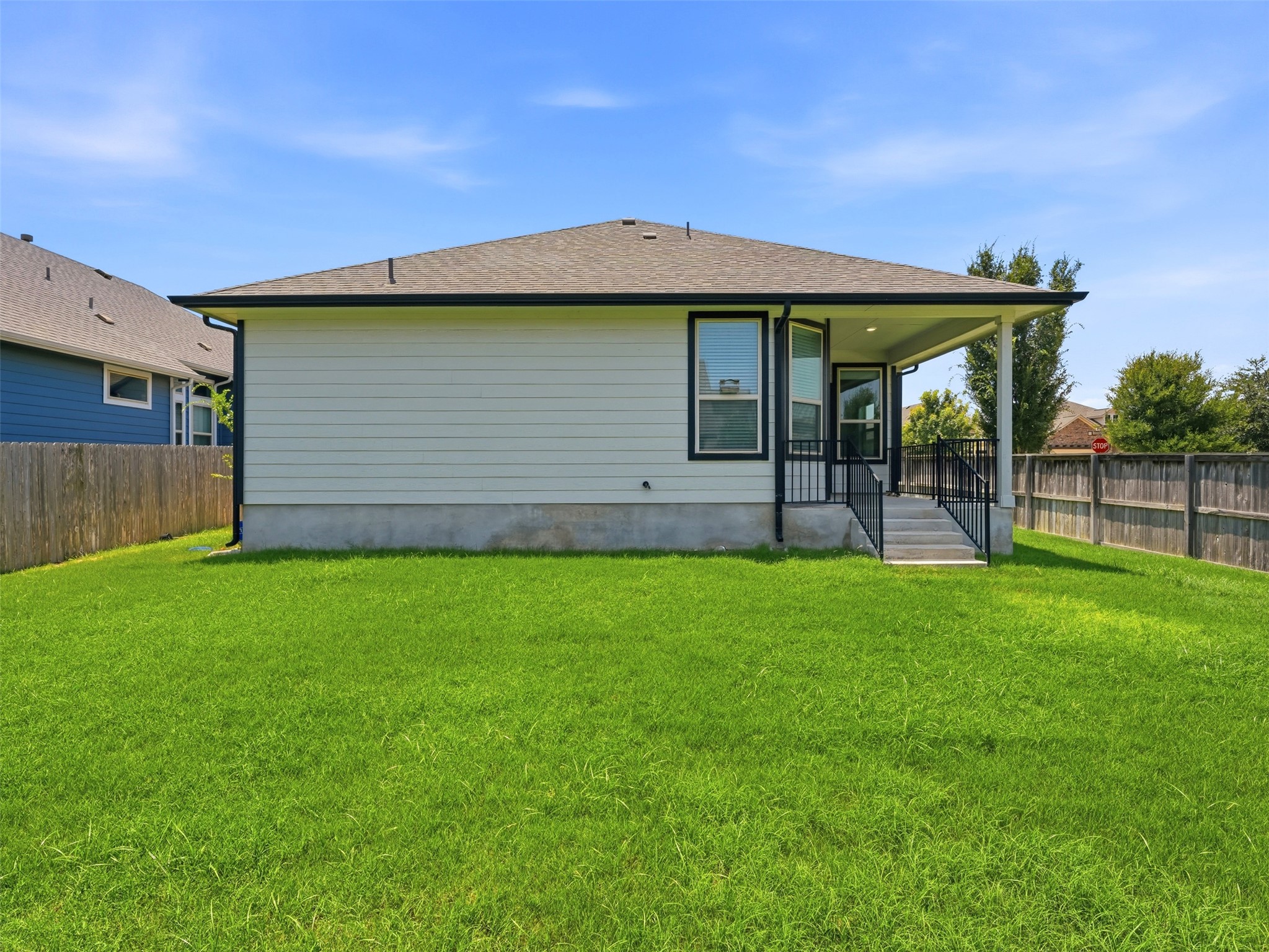 2132 Ringstaff Road Leander, TX 78641 - Photo 35 of 39 A well-kept green yard provides ample space for outdoor activities alongside a charming back patio.