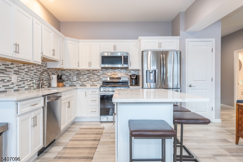 165 Lakeside Road, Unit 6 West Milford, NJ 07421 - Photo 2 of 23 a kitchen with stainless steel appliances granite countertop a stove a sink and a refrigerator
