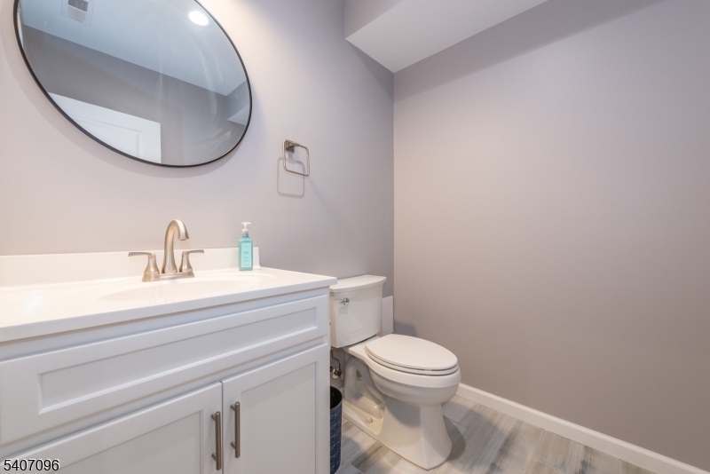 165 Lakeside Road, Unit 6 West Milford, NJ 07421 - Photo 9 of 23 a bathroom with a sink mirror and toilet