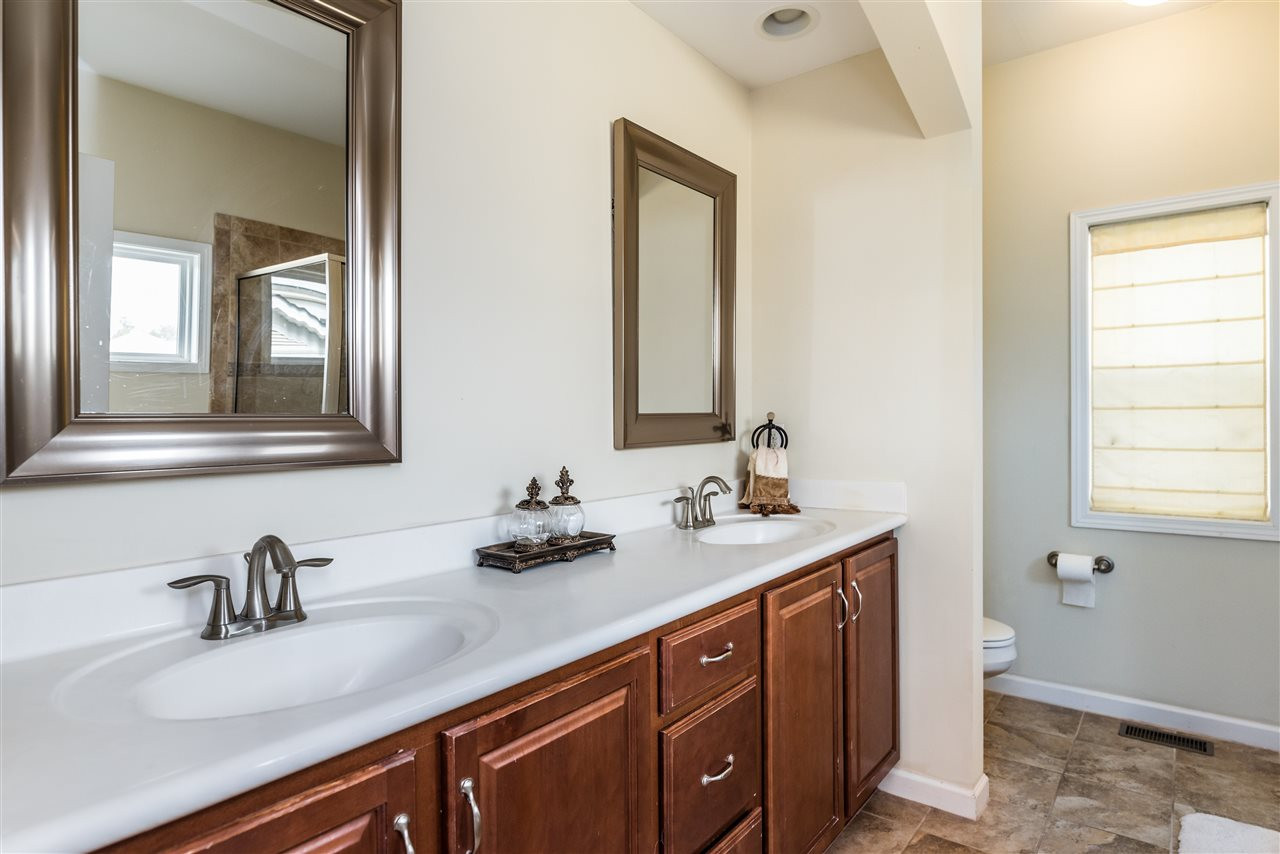1413 Van Page Boulevard Raleigh, NC 27607 - Photo 14 of 25 MASTER BATH INCLUDES TWO SINKS AND CERAMIC TILE FLOORING. MASTER BATH