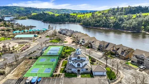 an aerial view of a house with a lake view