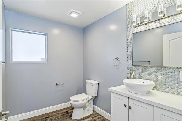 an empty room with windows and mirror