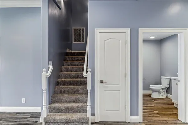 an empty room with windows and painted walls