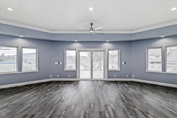 a kitchen with stainless steel appliances granite countertop a sink a stove a refrigerator and white cabinets