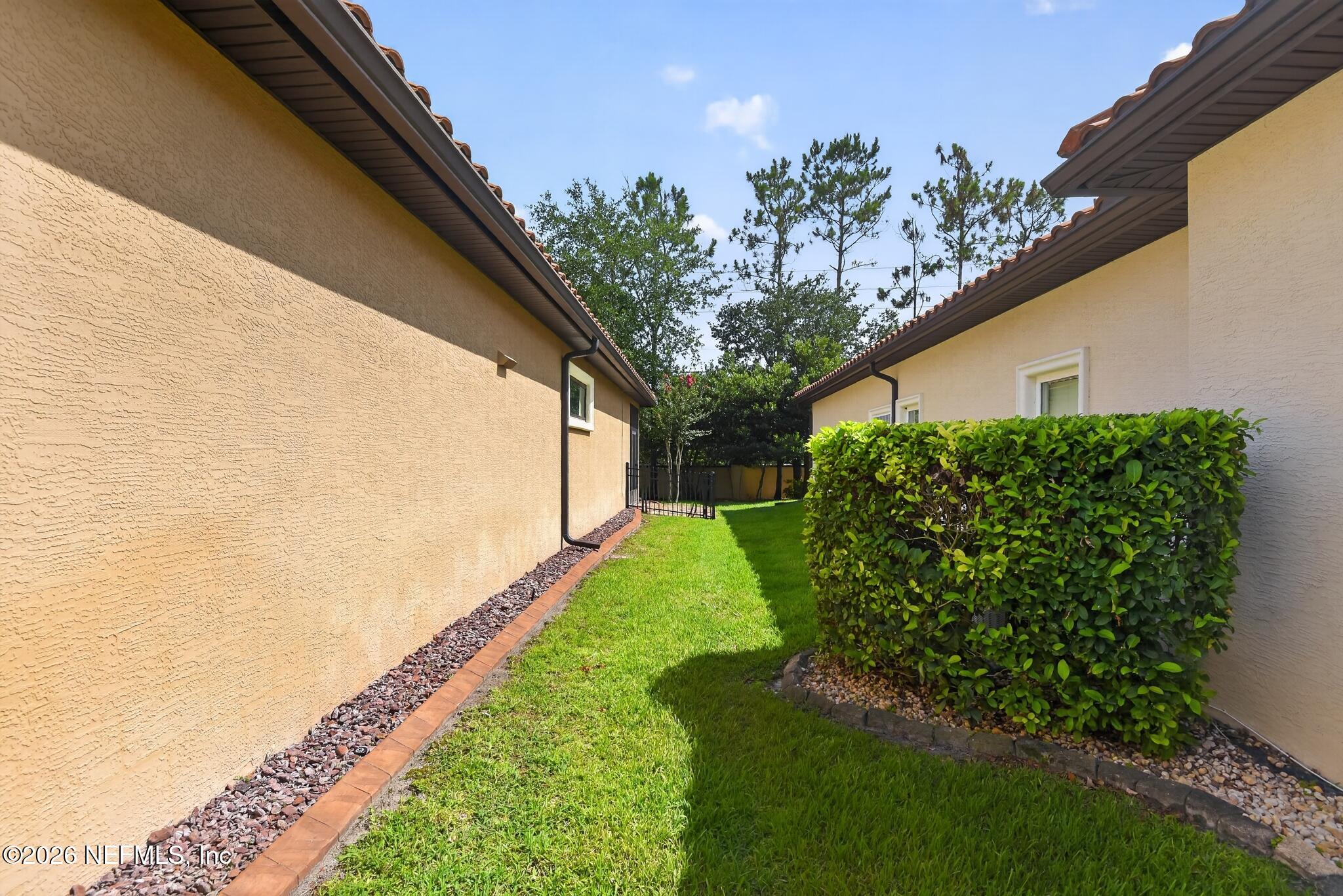 110 Vía Roma Ormond Beach, FL 32174 - Photo 21 of 43 a view of a yard with plants and a potted plant
