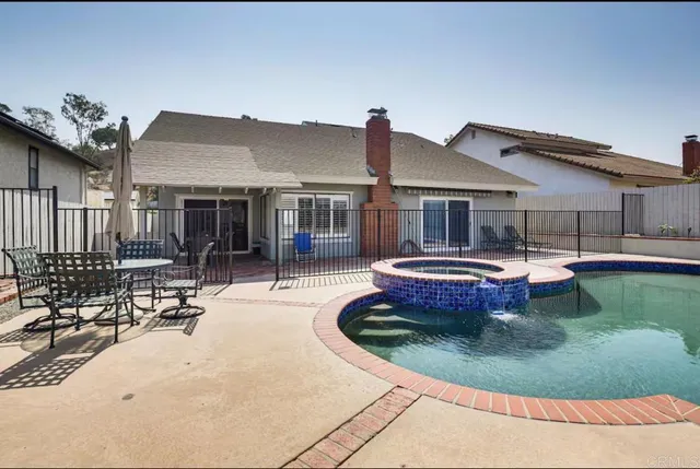 a view of a house with swimming pool and a sitting area