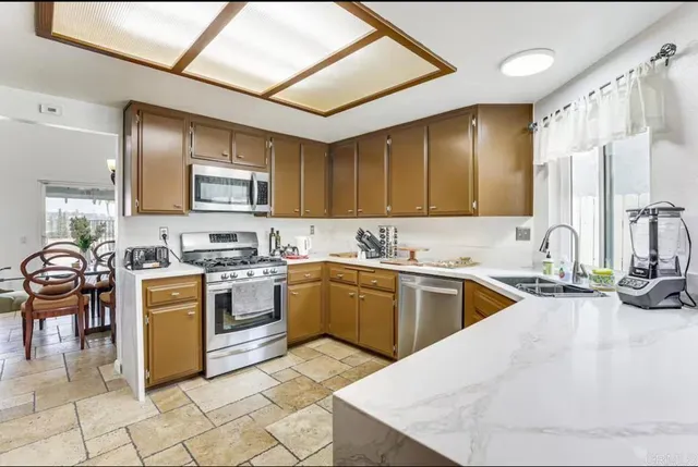 a kitchen with a stove top oven sink and cabinets