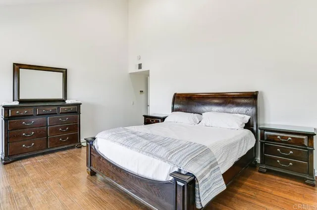 a bedroom with a bed and a dresser