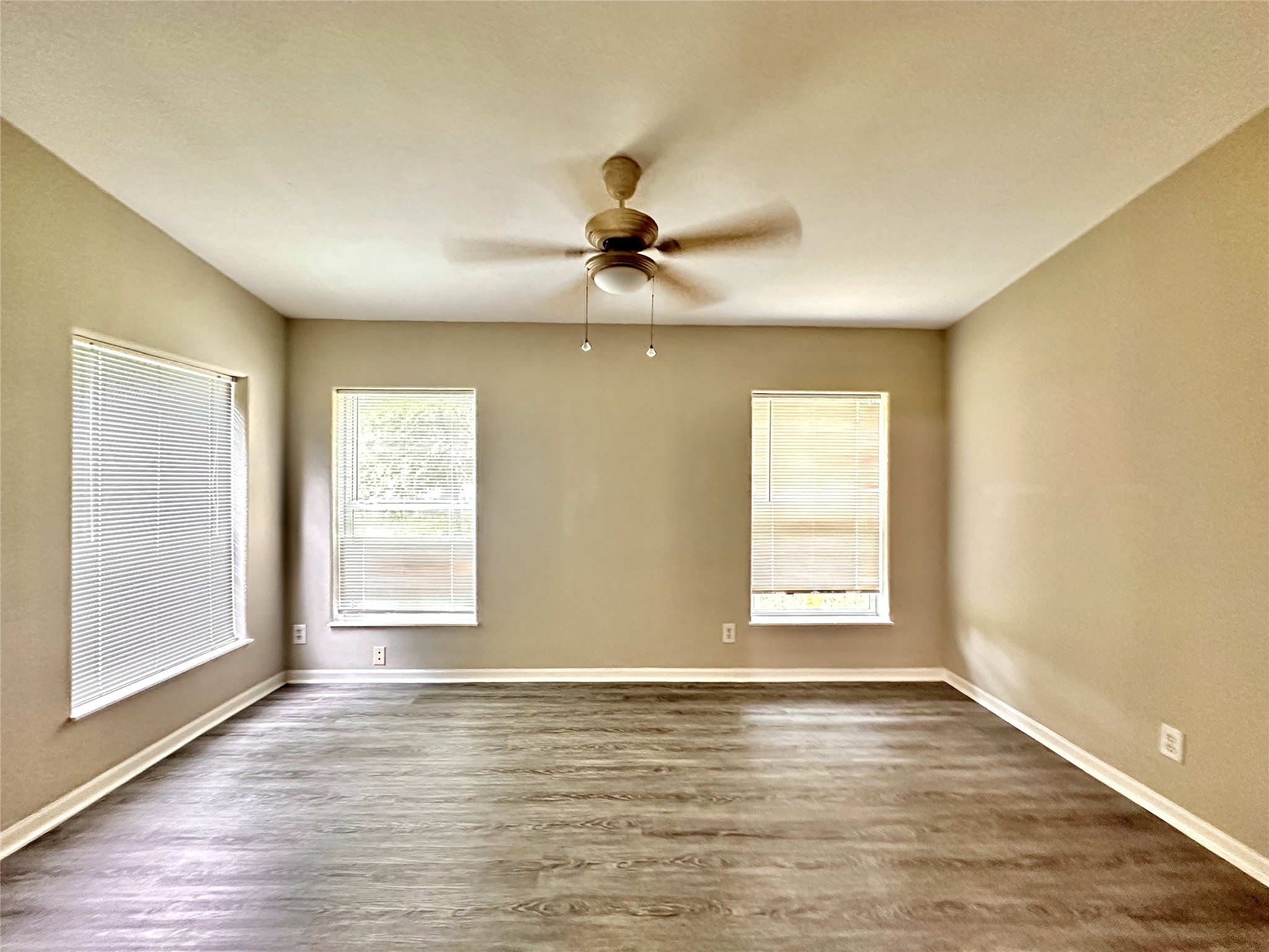 202 Main Street Fresno, TX 77545 - Photo 17 of 26 wooden floor in an empty room with a window