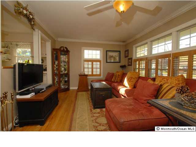 583 Hopping Road Middletown, NJ 07718 - Photo 3 of 3 a living room with furniture and a flat screen tv