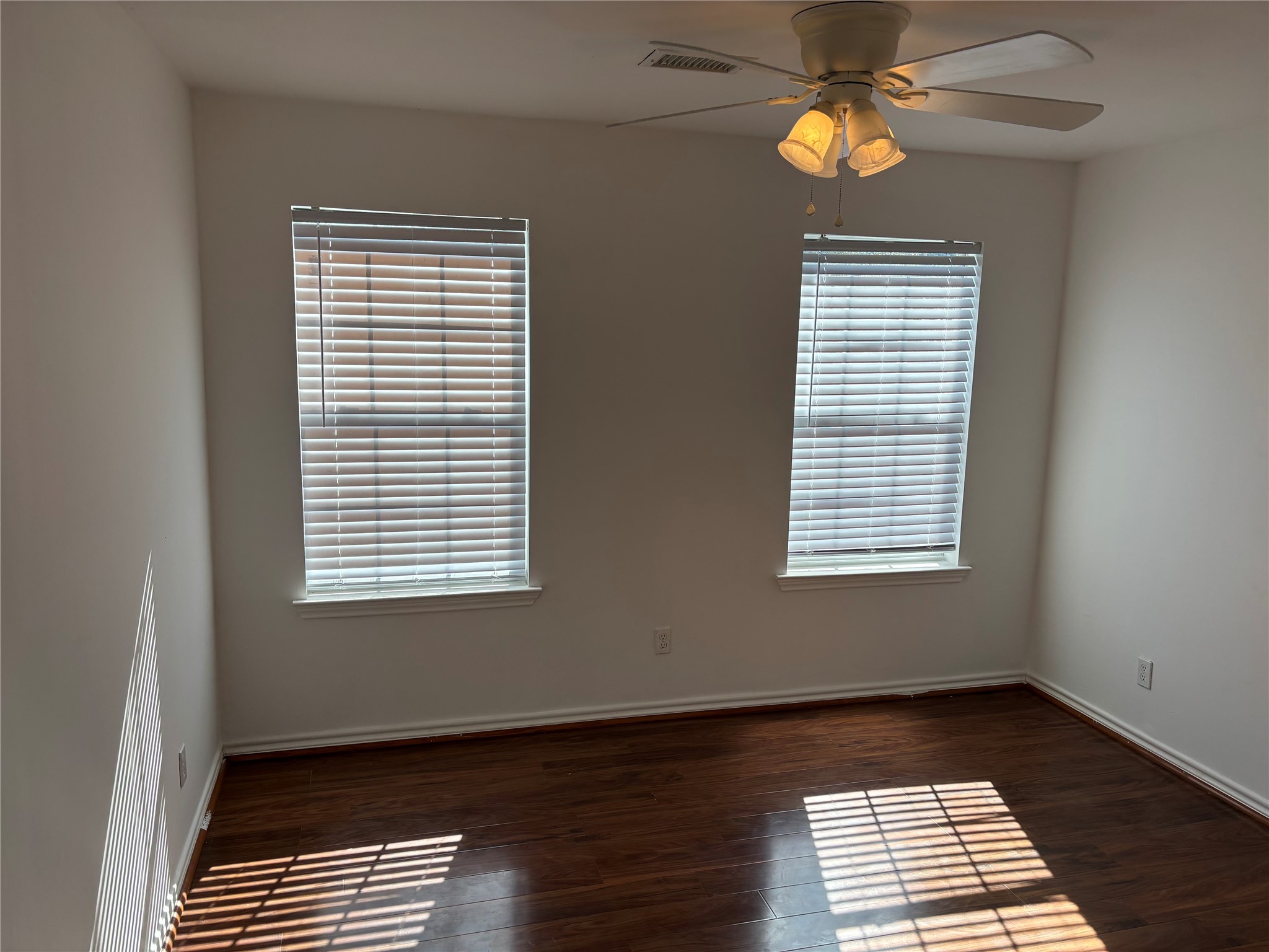 7834 Wolfield Lane Houston, TX 77071 - Photo 7 of 7 a view of an empty room with a window and wooden floor