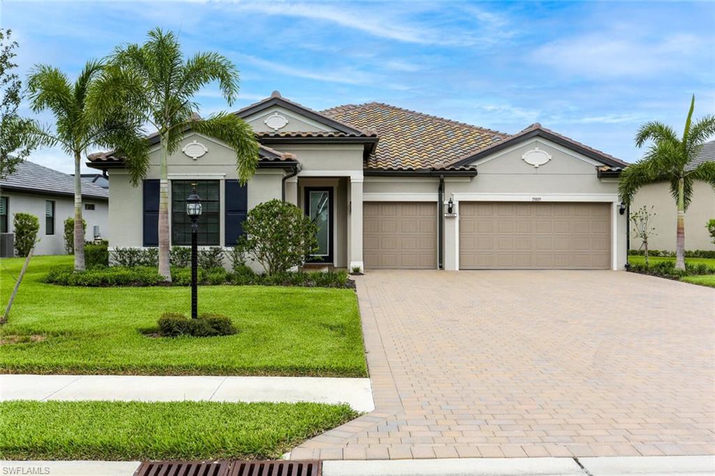 19809 Beechcrest Place Estero, FL 33928 - Photo 1 of 33 a front view of a house with a yard and garage