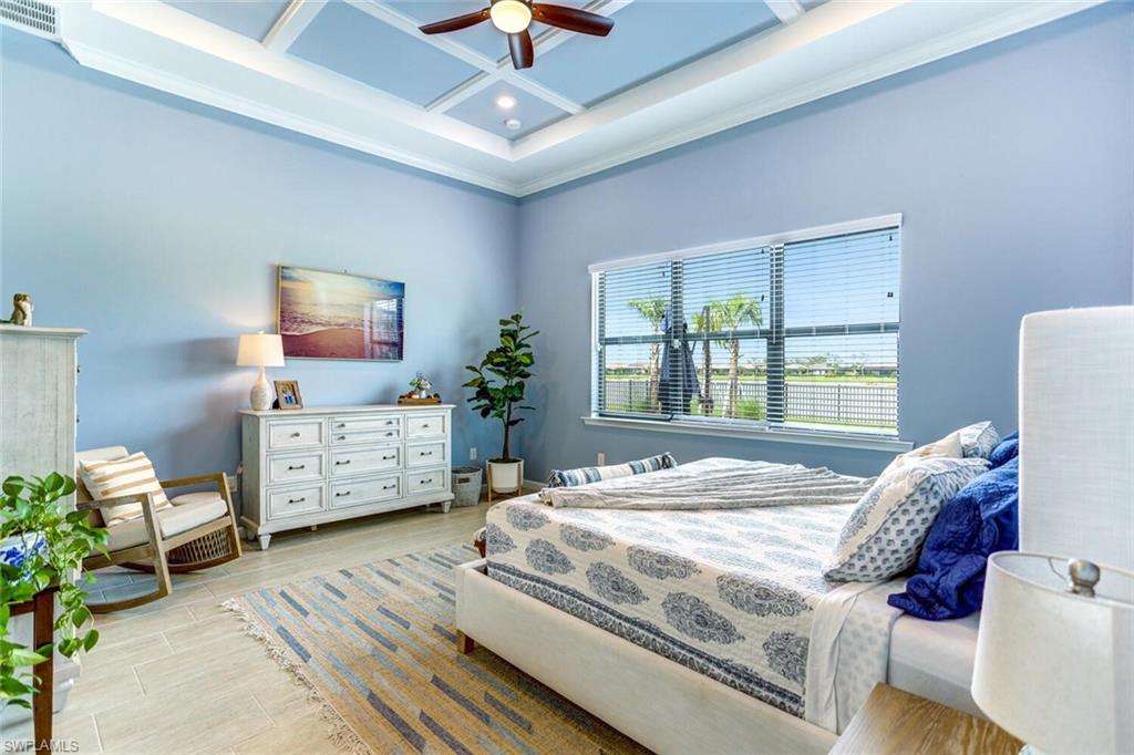 19809 Beechcrest Place Estero, FL 33928 - Photo 11 of 33 a bedroom with a bed and large windows