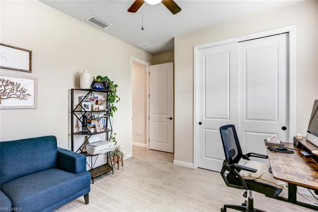 19809 Beechcrest Place Estero, FL 33928 - Photo 15 of 33 a view of a livingroom with workspace and a couch