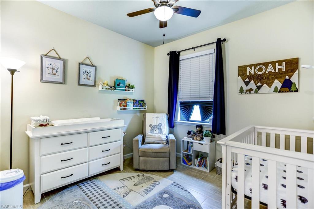 19809 Beechcrest Place Estero, FL 33928 - Photo 16 of 33 a living room with furniture and a baby crib