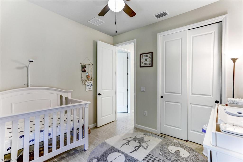 19809 Beechcrest Place Estero, FL 33928 - Photo 17 of 33 a spacious bedroom with a bed and a window