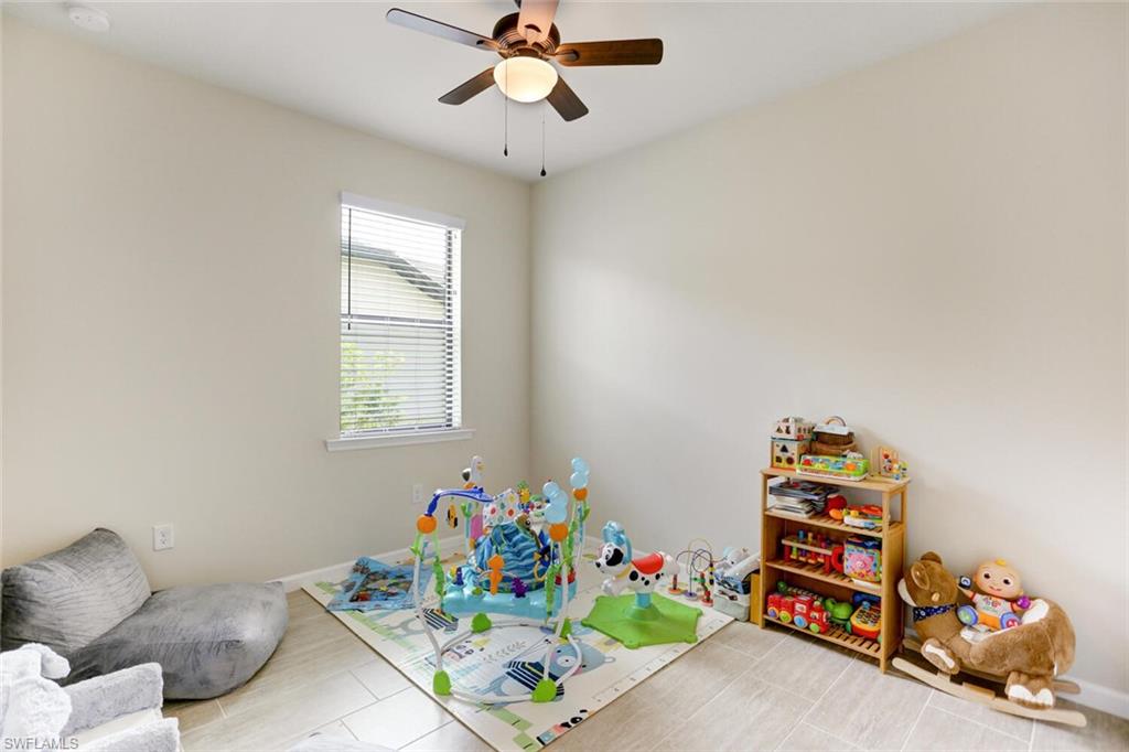 19809 Beechcrest Place Estero, FL 33928 - Photo 19 of 33 a room with toys and a couch