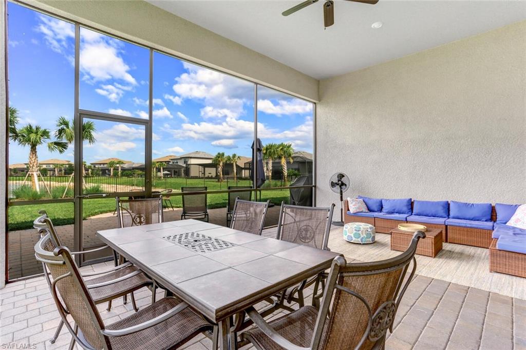 19809 Beechcrest Place Estero, FL 33928 - Photo 25 of 33 a view of a patio with a table chairs and a backyard