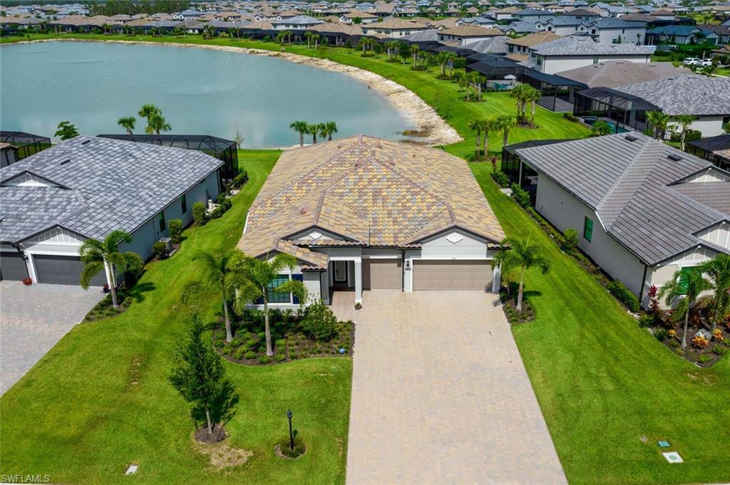 19809 Beechcrest Place Estero, FL 33928 - Photo 3 of 33 an aerial view of a house with a garden and lake view