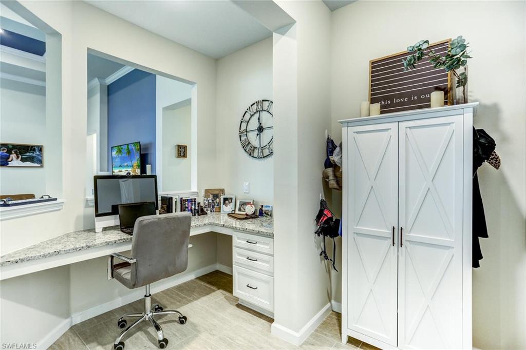19809 Beechcrest Place Estero, FL 33928 - Photo 9 of 33 a view of a workspace with furniture and wooden floor