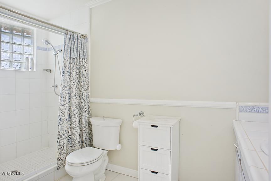 3560 Radcliffe Road Thousand Oaks, CA 91360 - Photo 14 of 26 a white toilet sitting next to a shower curtain