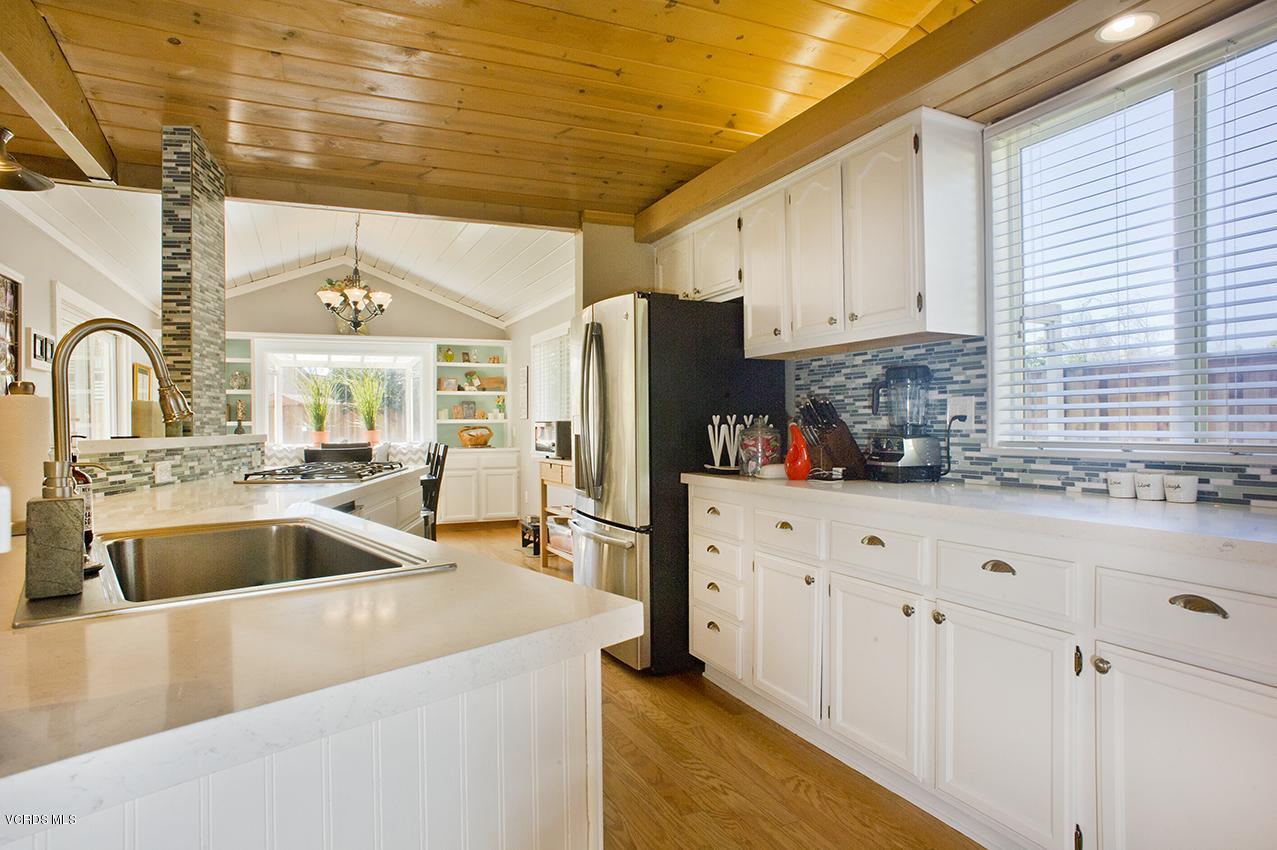 3560 Radcliffe Road Thousand Oaks, CA 91360 - Photo 7 of 26 a kitchen with stainless steel appliances granite countertop a sink a refrigerator and white cabinets
