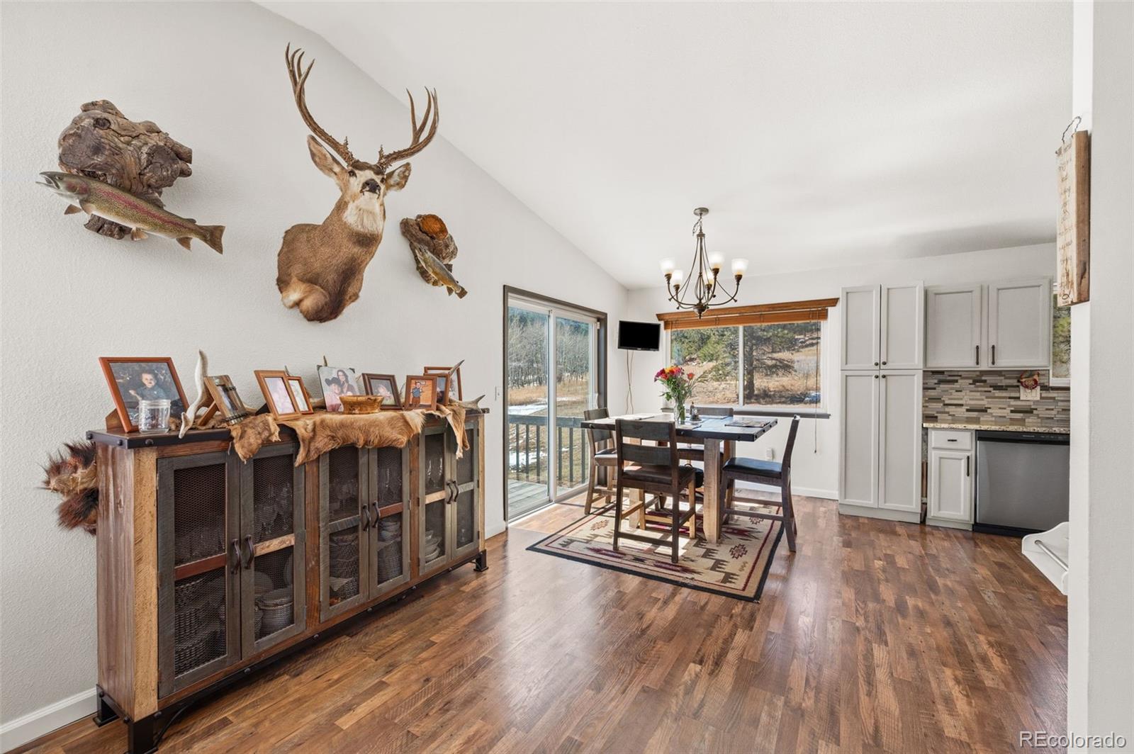 2222 County Road 72 Bailey, CO 80421 - Photo 11 of 50 a living room with furniture a dining table and chairs with wooden floor
