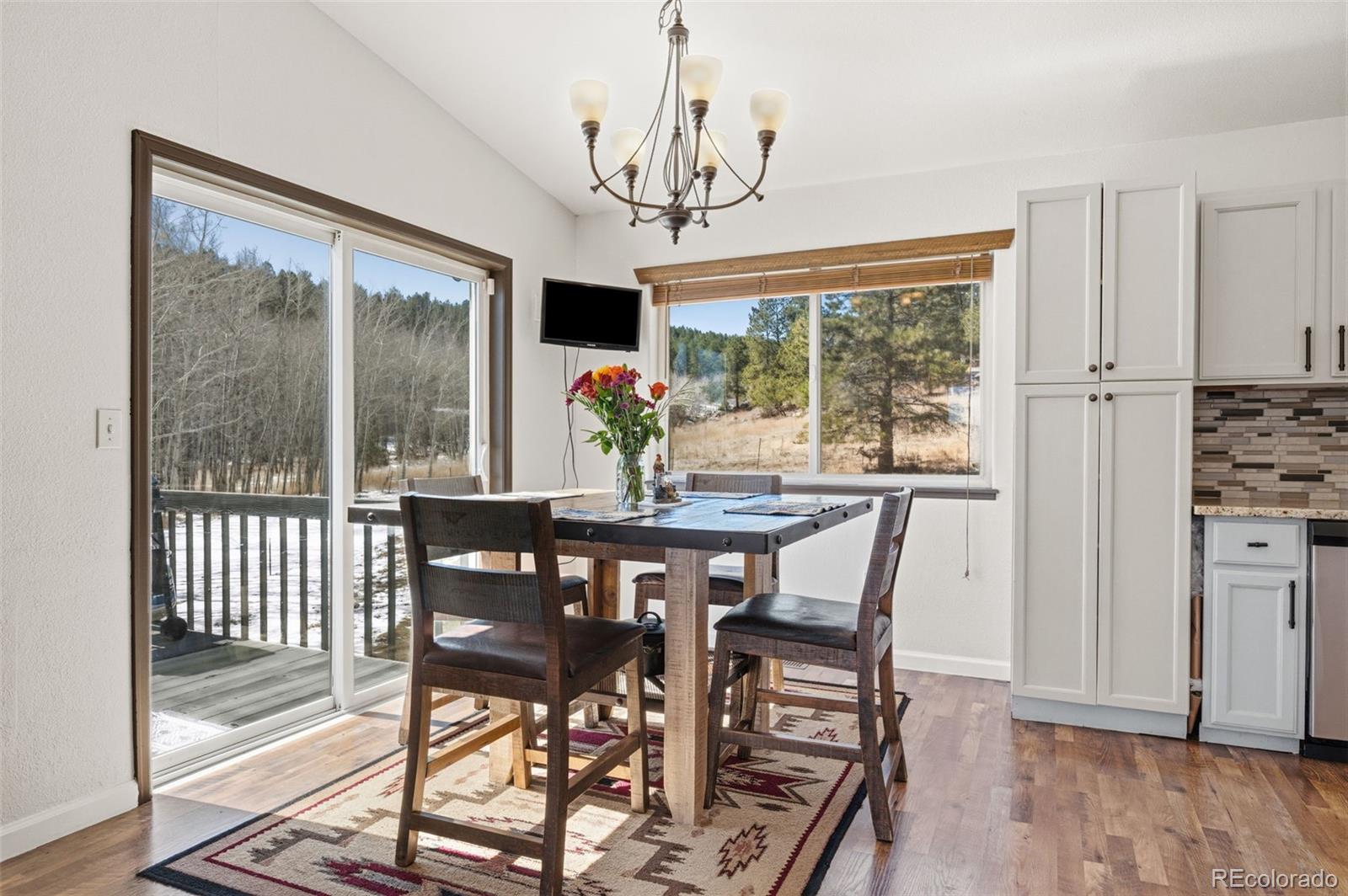 2222 County Road 72 Bailey, CO 80421 - Photo 12 of 50 a view of a dining room with furniture window and wooden floor