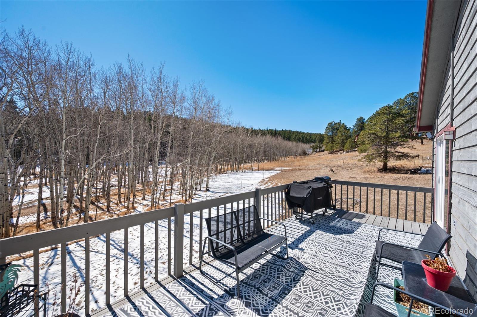 2222 County Road 72 Bailey, CO 80421 - Photo 15 of 50 a view of a balcony with wooden floor and outdoor seating