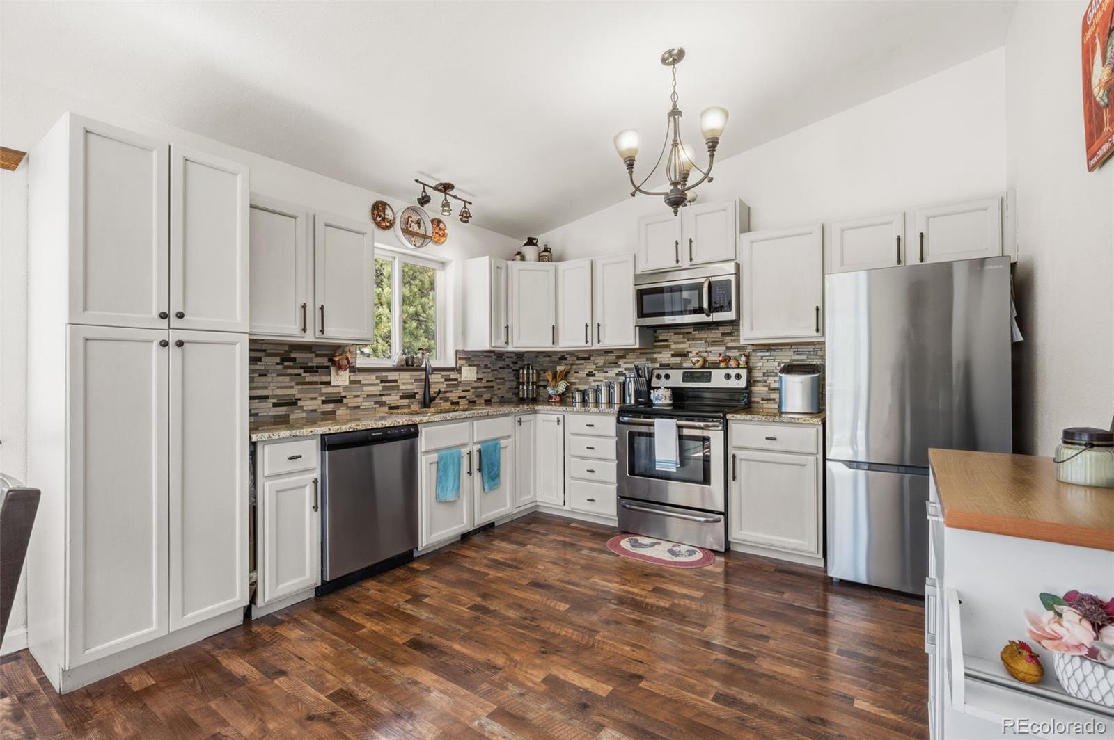 2222 County Road 72 Bailey, CO 80421 - Photo 17 of 50 a kitchen with a refrigerator cabinets and wooden floor