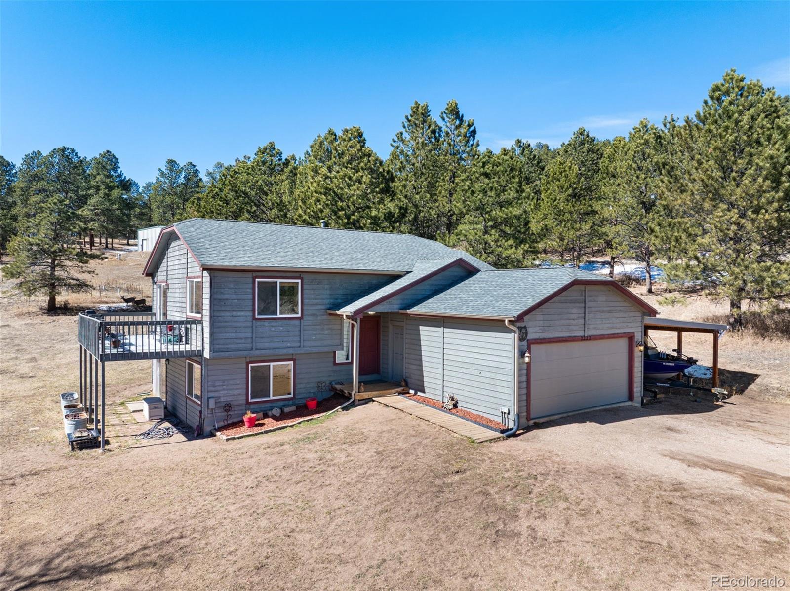 2222 County Road 72 Bailey, CO 80421 - Photo 2 of 50 a view of a house with a yard and large tree