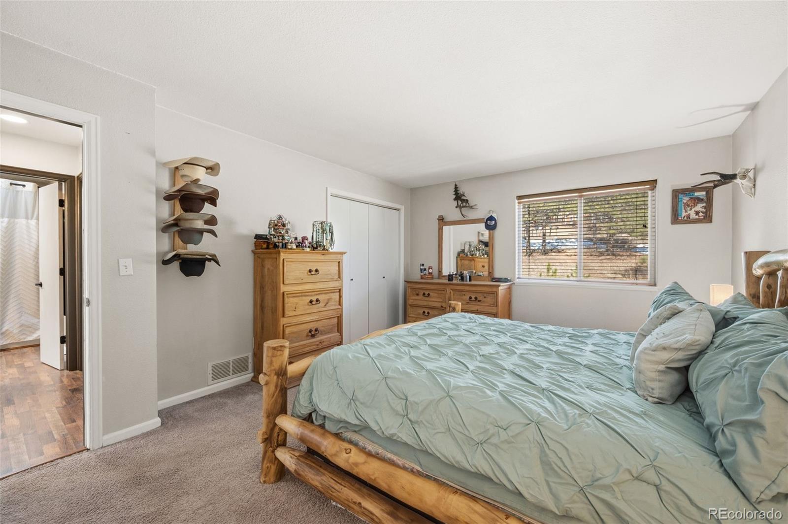 2222 County Road 72 Bailey, CO 80421 - Photo 21 of 50 a bedroom with a bed and dresser