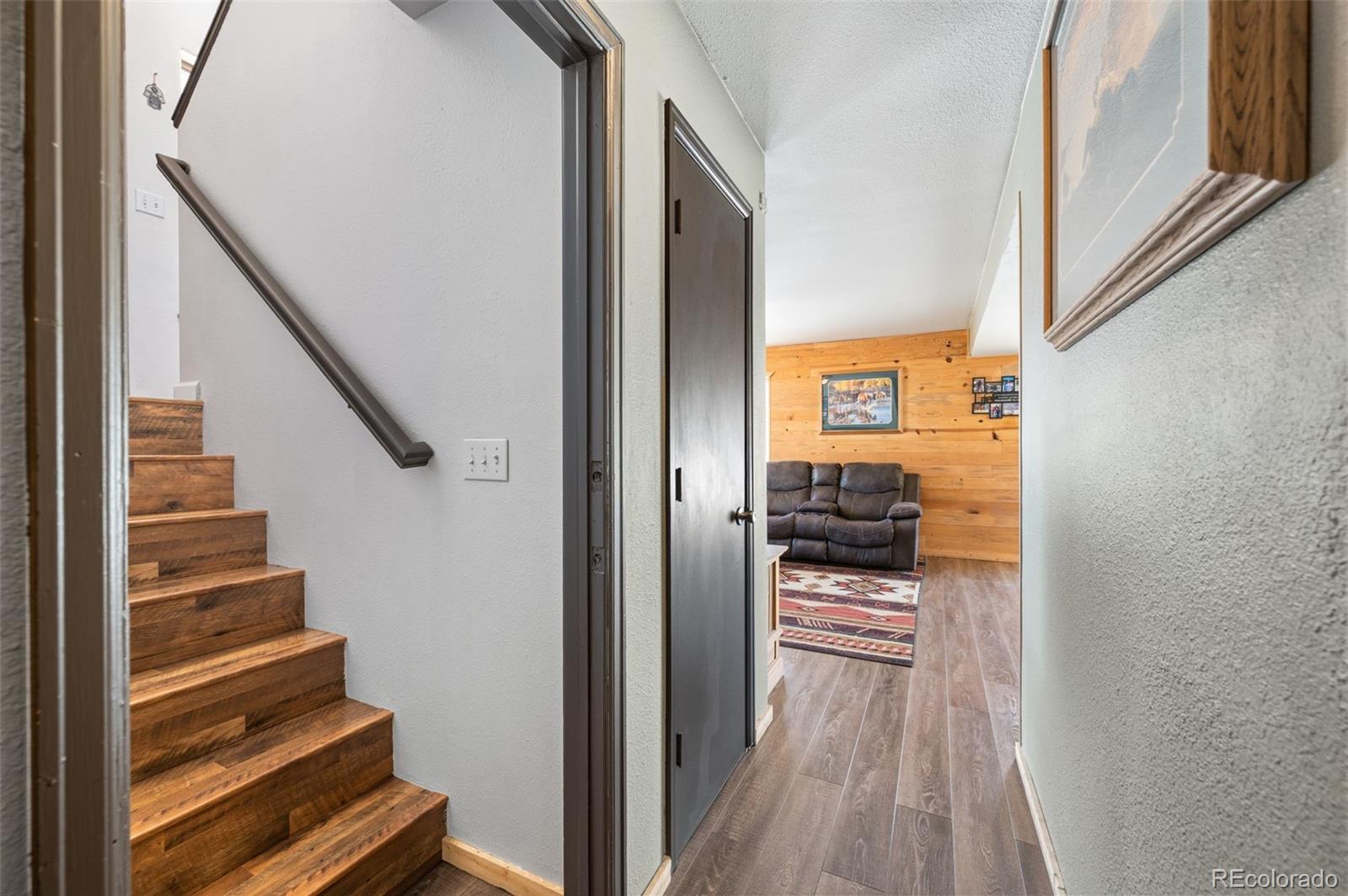 2222 County Road 72 Bailey, CO 80421 - Photo 25 of 50 a view of a hallway with wooden floor and staircase