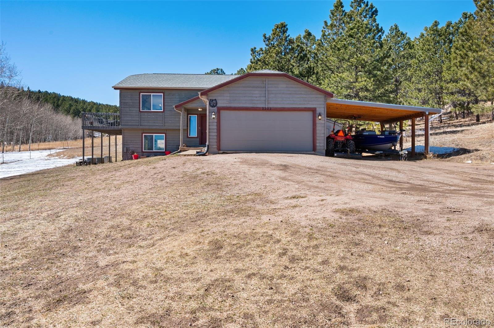 2222 County Road 72 Bailey, CO 80421 - Photo 3 of 50 a front view of a house with a yard and garage