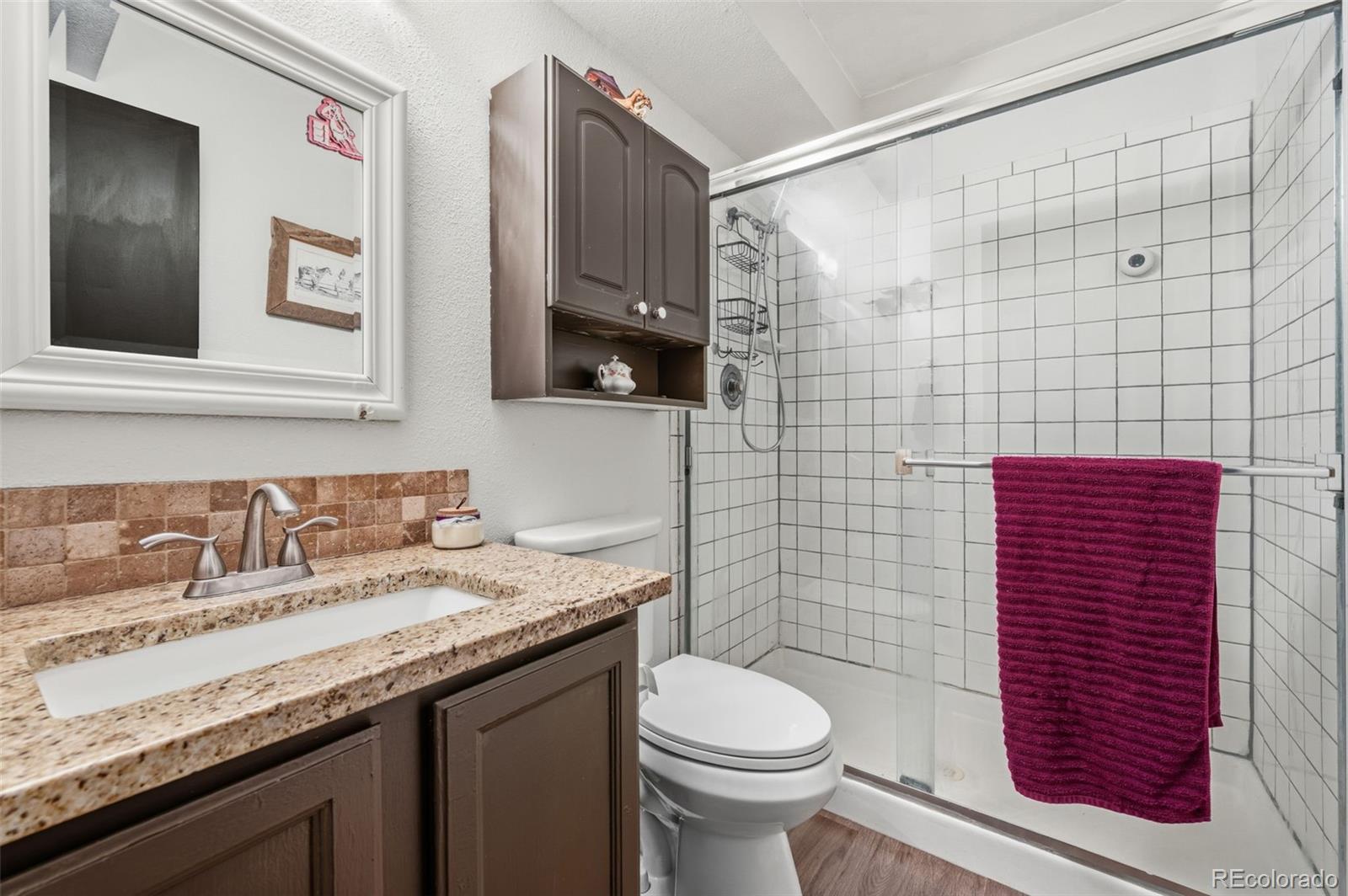 2222 County Road 72 Bailey, CO 80421 - Photo 31 of 50 a bathroom with a granite countertop toilet sink and mirror