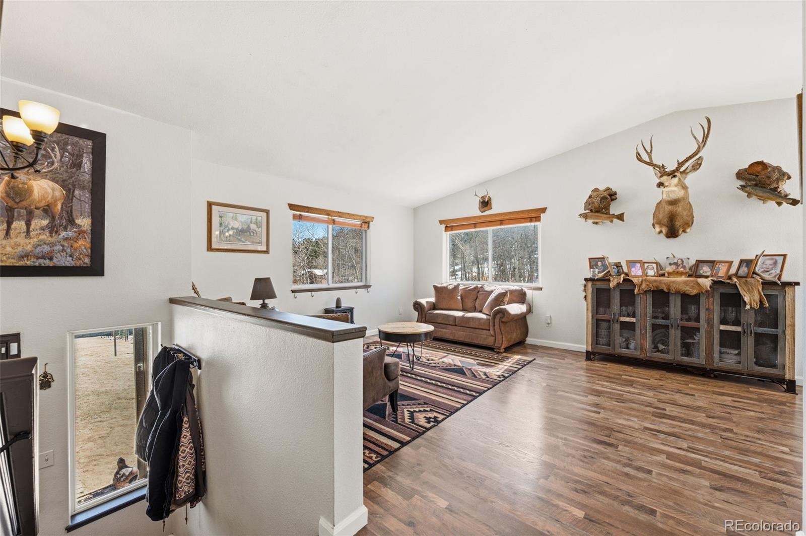 2222 County Road 72 Bailey, CO 80421 - Photo 6 of 50 a living room with furniture a flat screen tv and a refrigerator