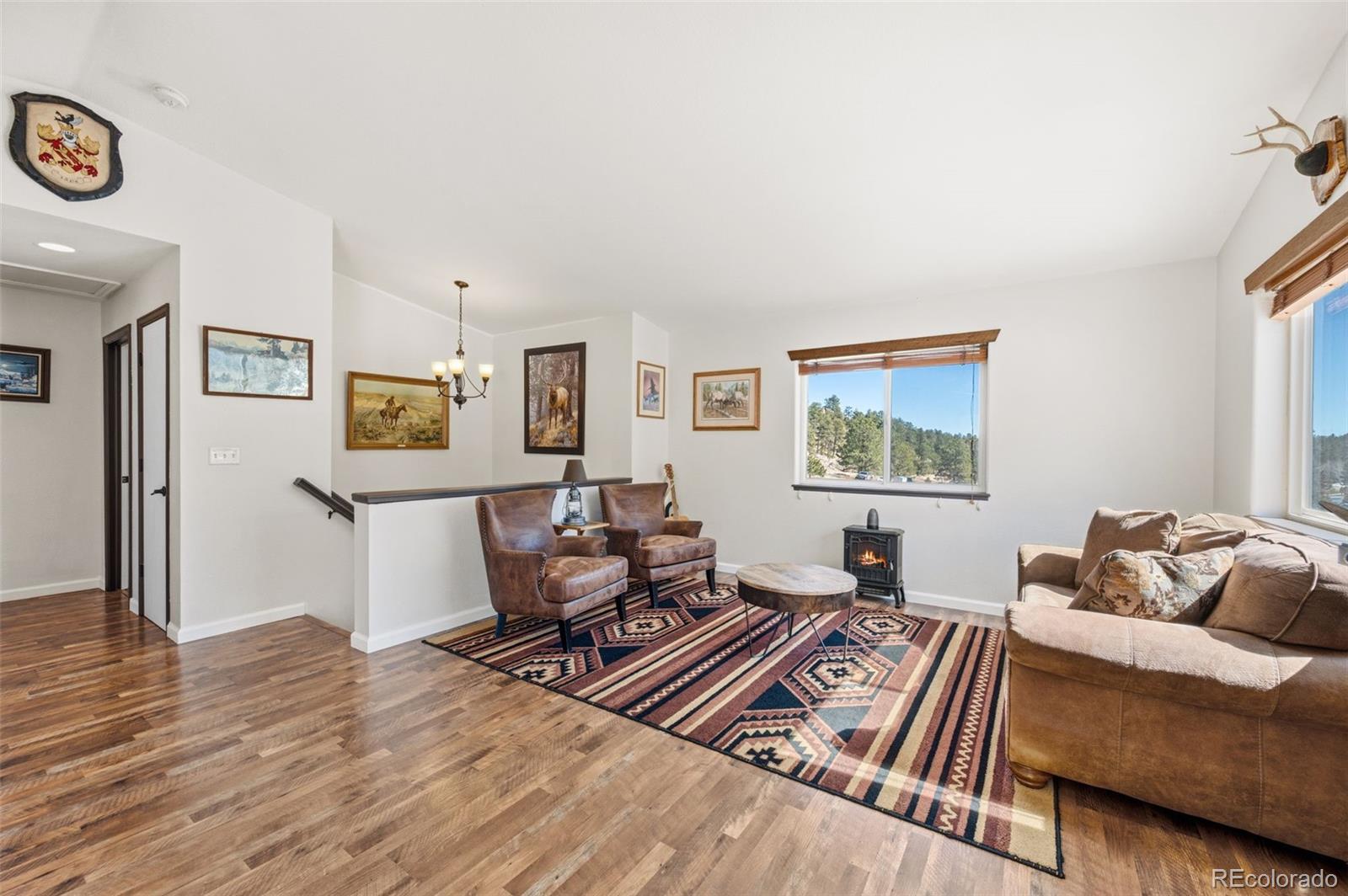 2222 County Road 72 Bailey, CO 80421 - Photo 9 of 50 a living room with furniture and a wooden floor