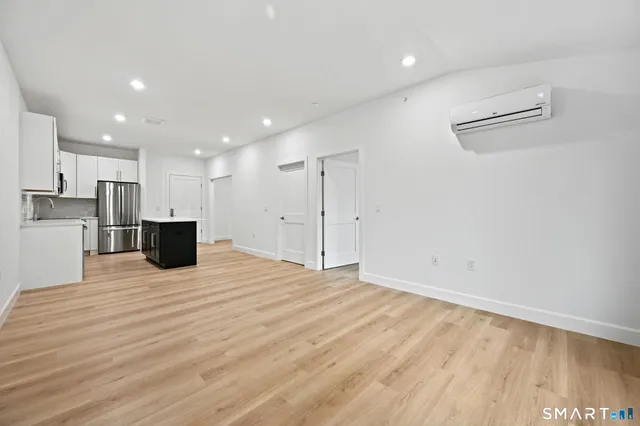 a view of a kitchen with a sink and a refrigerator