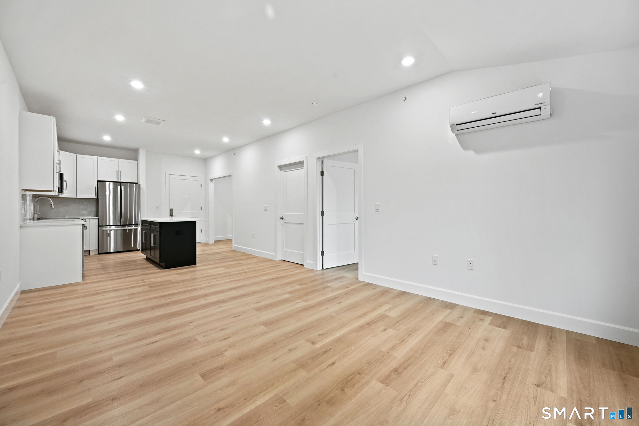 131 Beach Road, Unit 202 Fairfield, CT 06824 - Photo 16 of 32 a view of a kitchen with a sink and a refrigerator