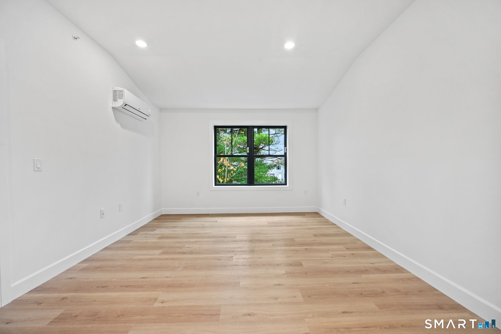 131 Beach Road, Unit 202 Fairfield, CT 06824 - Photo 18 of 32 wooden floor in an empty room with a window