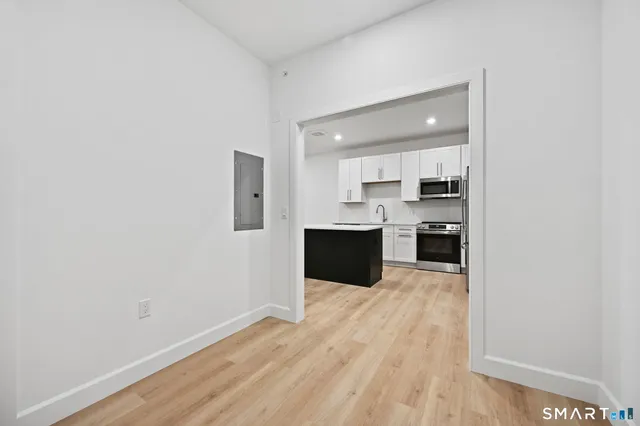 a large white kitchen with cabinets