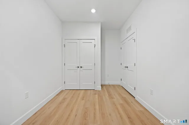 a view of room with wooden floor