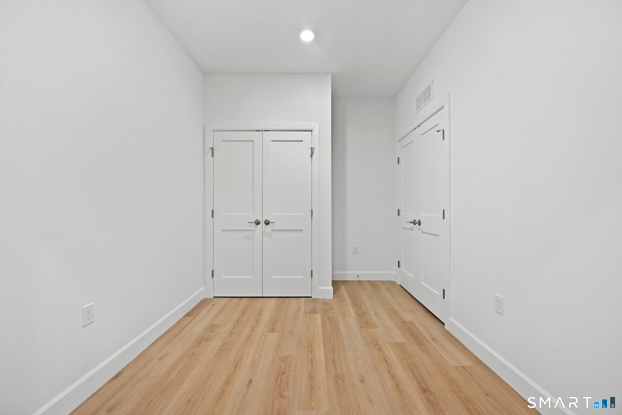 131 Beach Road, Unit 202 Fairfield, CT 06824 - Photo 22 of 32 a view of room with wooden floor