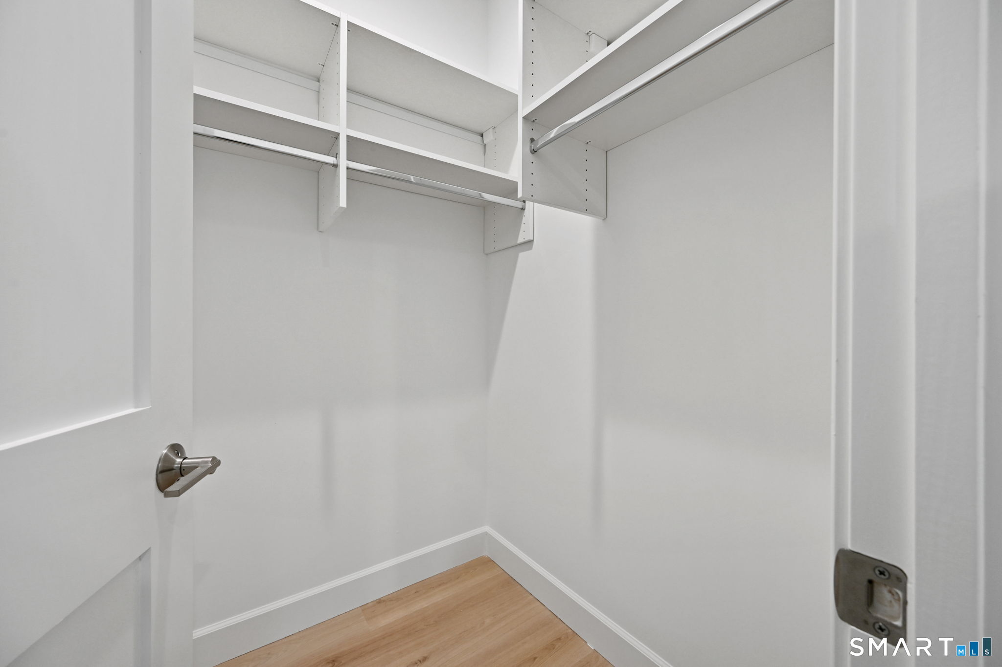 131 Beach Road, Unit 202 Fairfield, CT 06824 - Photo 28 of 32 a view of walk in closet with empty racks