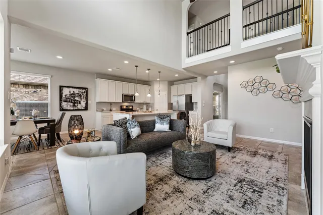a living room with furniture wooden floor and a chandelier
