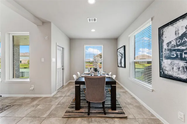 a dining room with wooden floor and a window