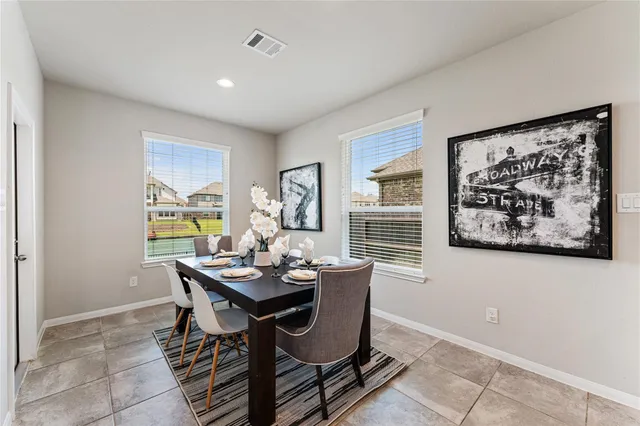 a dining room with furniture and window